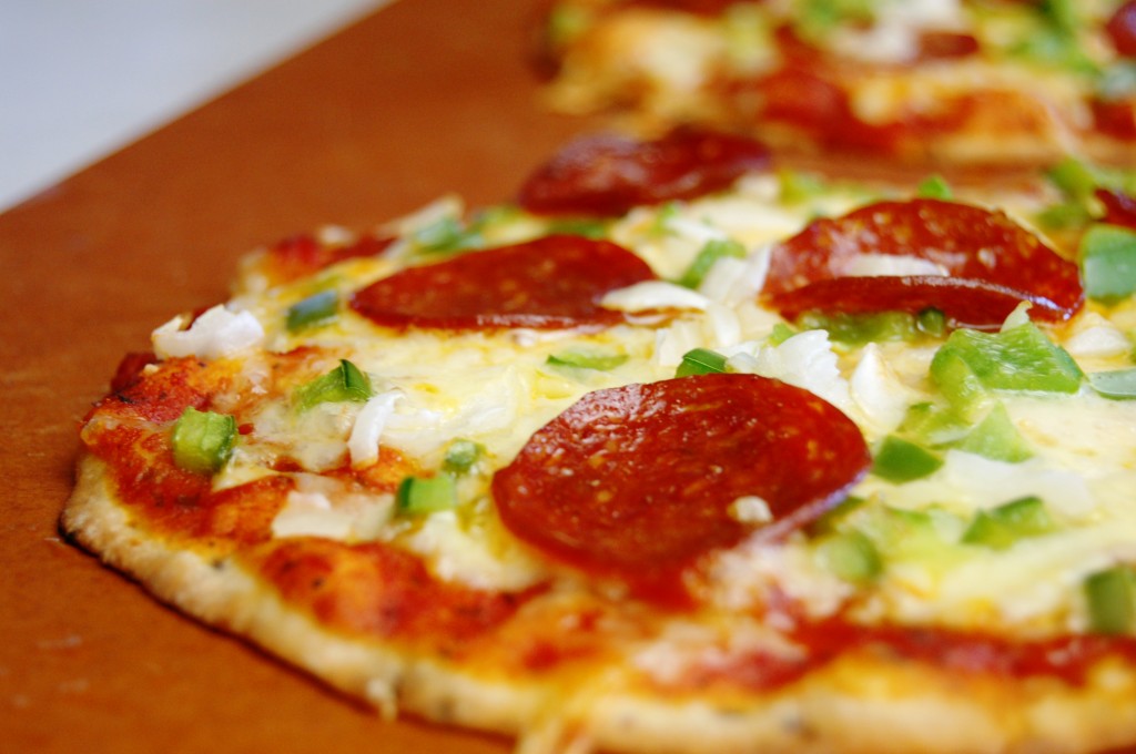     Butter or coconut oil ONE side of your tortilla and lay buttered side DOWN on a silpat or parchment paper lined baking sheet.     Top with the rest of your pizza toppings how you like!     Bake at 375 degrees for 12-15 minutes. Keep an eye on them around the 12 minute mark in case your oven runs differently.